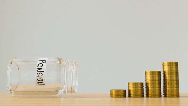 Empty Jar With The Inscription Pension And Coins On A Wooden Table