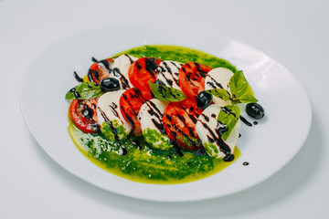 tender mozzarella cheese with tomatoes and olives healthy eating isolated on white background