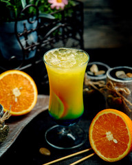 orange cocktail with ice on the table