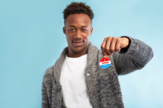 African american Voter holding pin with I Voted Today text