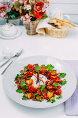 spicy salad with chili peppers and pieces of chicken with rice on a white background