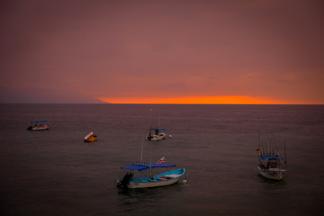 Naklejka na ściany i meble Boats at at a sunset on Puerto Vallarta beach.