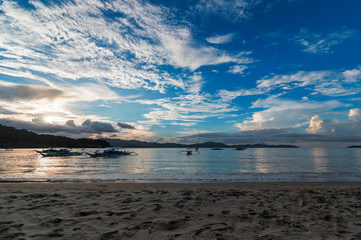 Obraz premium Beautiful sunset in the beach of Port Barton in a cloudy sky evening