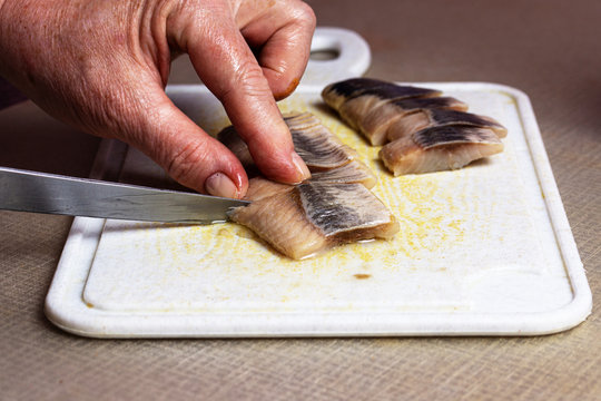the process of cutting fillets of salted fish for making snacks