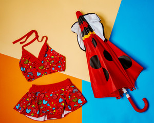 red split swimsuitfor girls and red polka dot umbrella