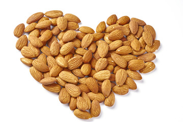 Almond nuts forming a heart shape isolated on white background