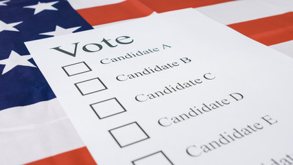 Voting for Presidential elections 2020 with ballot on American flag.