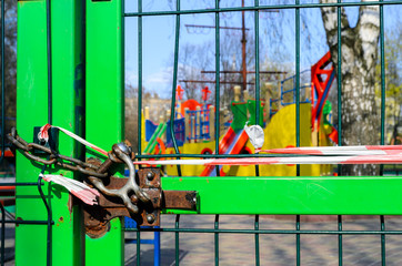 The closed gates of playground due to the prohibition of its visits during the quarantine of the pandemic of COVID-19 disease caused by coronavirus