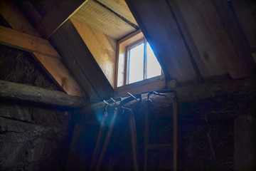 Light through window in dark old room from farm