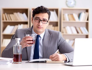 Young businessman drinking from stress
