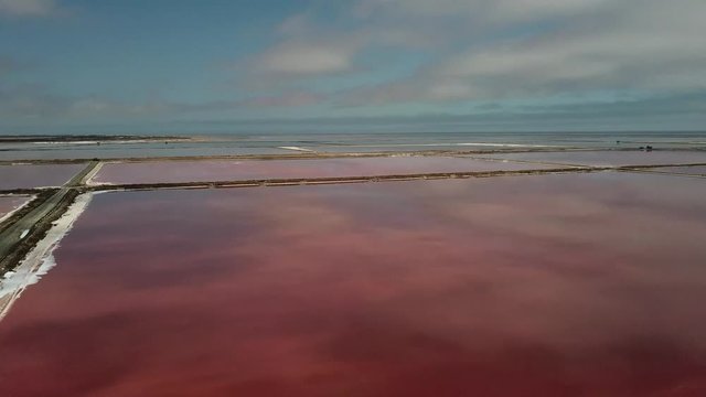 4K aerial drone video of salt works factory wide pink salty water evaporation ponds, in outskirts of coastal harbour town Walvis Bay, Namib Desert, Atlantic Ocean west coast, Namibia, southern Africa