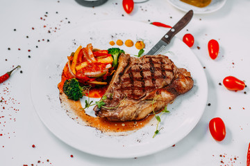 grilled beef steaks with spices isolated on white background