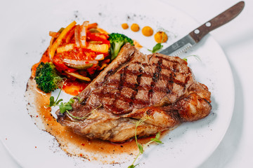grilled beef steaks with spices isolated on white background