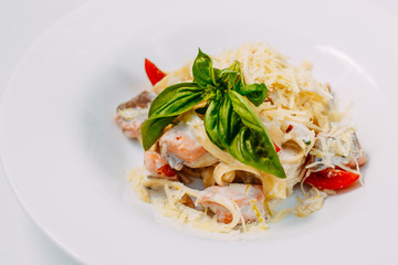 fettuccine pasta with red tomato fish and cheese