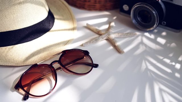 Travel accessories on the table with shadow of plam leave, Summer vacation concept