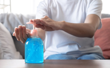 Work from home, Asian women working at home, She wears a protective mask and cleans her hands with a sanitizing gel.