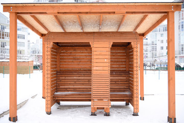 Obraz na płótnie Canvas Empty wooden bus stop in a winter city