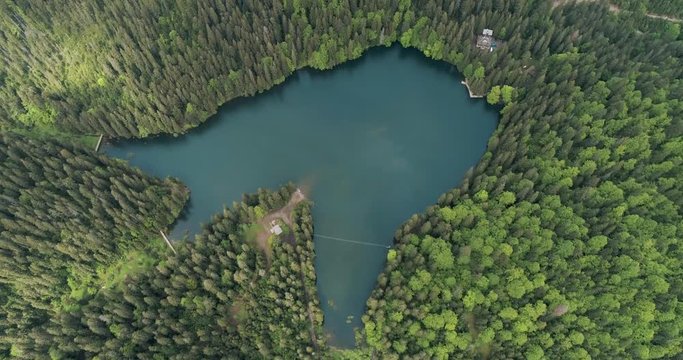 Mountain lake with turquoise water and green trees. Aerial view of Lake Synevir in Carpathian Mountains in Ukraine. 4k video. 