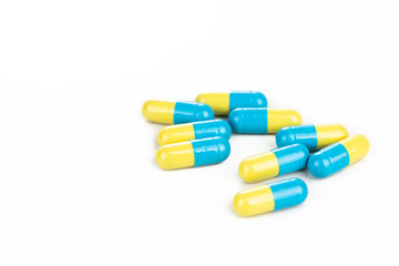 Close-up of group of medicine in capsule format on white background
