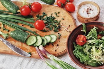 Dietary food background: vegetable salad with cherry tomatoes and cucumbers, vegan cuisine