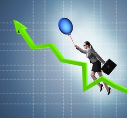 Businesswoman flying on hot balloon over graph
