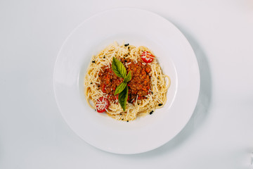 italian pasta bolognese with tomatoes and basil isolated on white background