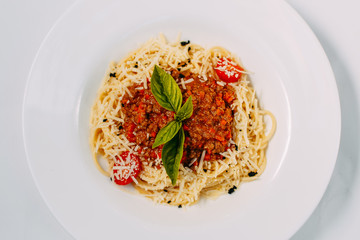 italian pasta bolognese with tomatoes and basil isolated on white background