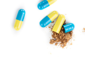Close-up of opened medicine capsule revealing powder active drugs ingredients