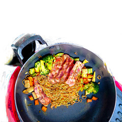 Stir-fry Instant noodles korean hot chili ramen stlye with smoke pork bacon in cooking pan.