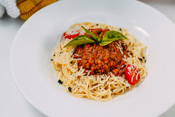 italian pasta bolognese with tomatoes and basil isolated on white background