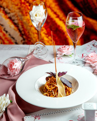 spaghetti with stuffed meat in sauce and parmesan