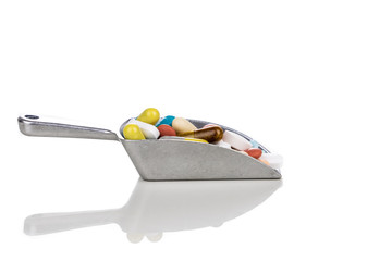 Healthcare concept of ladle with scoop of various medicine tablet, caplets, pills, capsule.