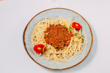 italian pasta bolognese with tomatoes and basil isolated on white background