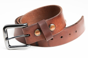 A formal studio product shot of a men’s used brown leather belt with patina set on plain white background.