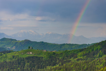 Slovenian breathtaking landscape with Julian Alps and charming little church of Sveti Tomaz (Saint...