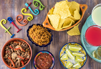 Mexican fiesta table with food and drinks.