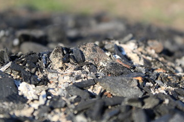 black coals and ashes from a street fire