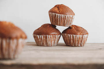 Chocolate cupcakes on wooden table background. Copy, empty space for text