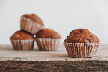 Chocolate cupcakes on wooden table background. Copy, empty space for text