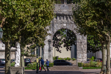 Ancient arch and modern blue sculpture in the historic center of Aix-les-Bains, France