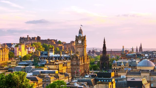 Edinburgh, UK. Aerial view of Edinburgh, Scotland. The city with Castle and Clock Tower during the evening. Cloudy sunset sky. Time-lapse at sunset, zoom in