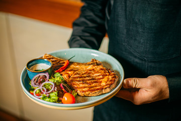 steak with vegetables and sauce on a plate