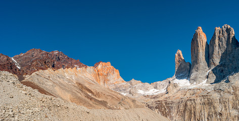 Fototapeta premium Panoramic view over beautiful Torres del Paine National Park, its high three major peaks as gigantic teeth, Patagonia, Chile, sunny day, blue sky