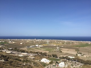 Fototapeta na wymiar Santorini, Greece on the 2nd April 2018 - a wilderness of grass and weeds near the sea in Santorini