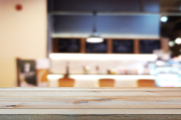 wooden table with abstract blurred background resturant lights used for display montage products mock up design.