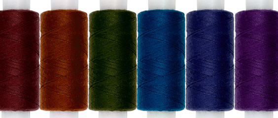 Directly Above Shot Of Colorful Spools Over White Background