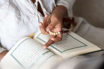 Quran - holy book of Muslims religion, Concept: open book holy prayers for god, Friday In the month of Ramadan  religion Islamic worshiping faith and learn koran and rosary put on wooden  boards 