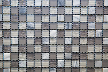 Mosaic of glass and stone in gray and white blue color in the form of small squares. Design backgrounds textures construction