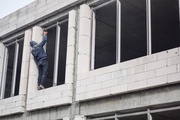 A man works at a building. Construction work. Building construction close up