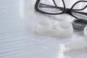 Contact lenses in container, bottle with solution, glasses - 337760527